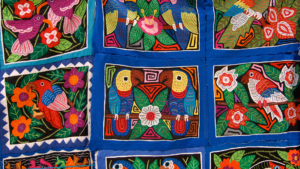 Panamanian mola, with pictures of native birds against a blue square background.